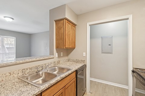 A kitchen with a sink and a dishwasher.