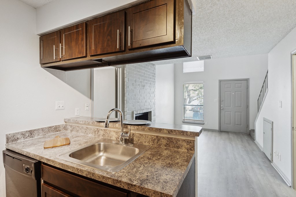 an empty kitchen with a sink and a counter top at Maxwell Townhomes, Texas
