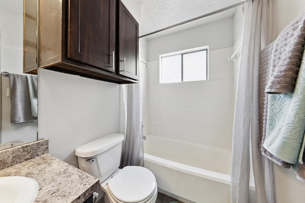 a bathroom with a toilet and a sink and a shower at Maxwell Townhomes, San Antonio, 78230