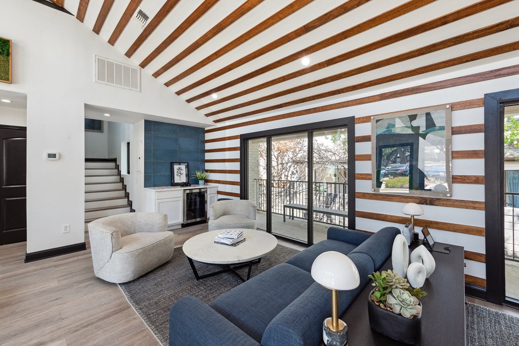 Clubhouse with a blue couch and a coffee table at Maxwell Townhomes, San Antonio, 78230