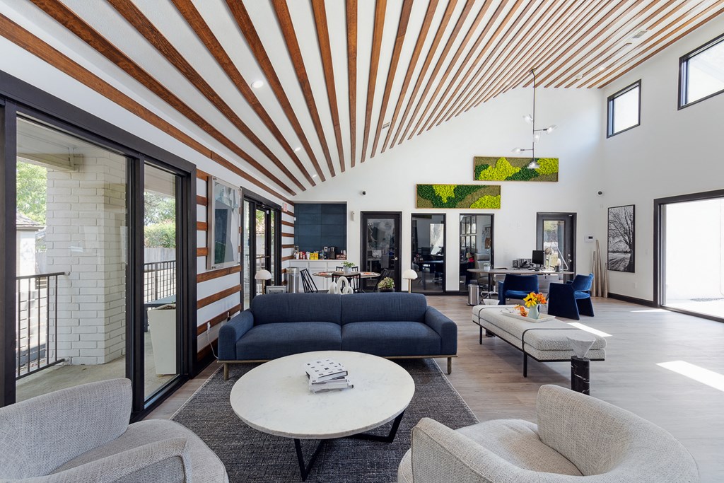 Community clubhouse with a blue couch and a white coffee table at Maxwell Townhomes, San Antonio, Texas