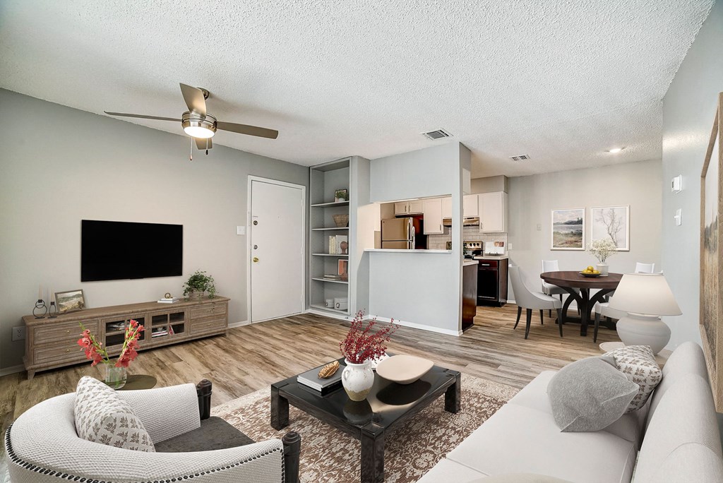 our apartments offer a living room with a couch a coffee table and a flat screen tv