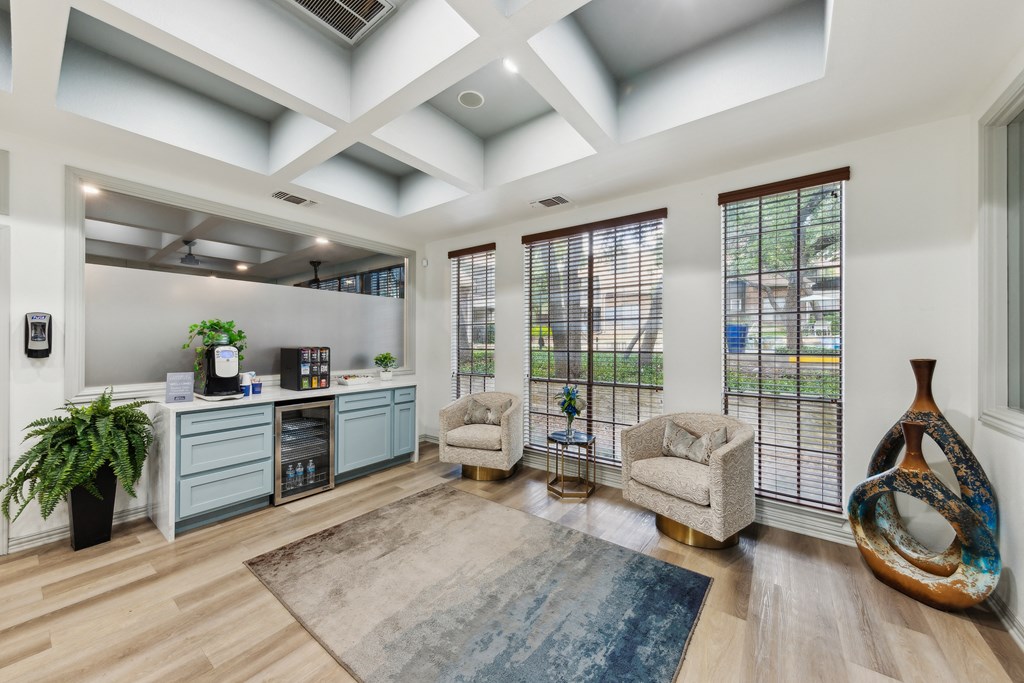 Leasing Office with two chairs and a desk and windows