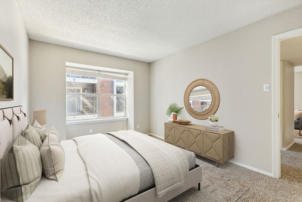Bedroom with large windows at The Hamptons, Texas