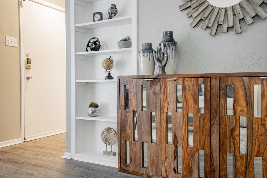a living room with a wooden cabinet and a mirror on the wall at Aero White Rock, Dallas, TX