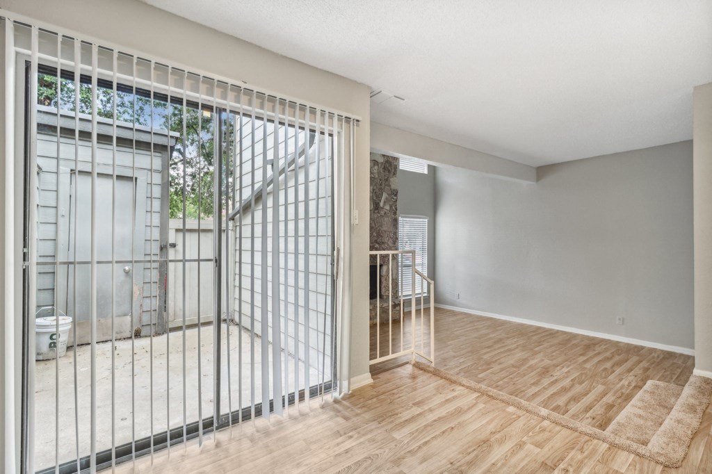a living room with a sliding glass door to a balcony