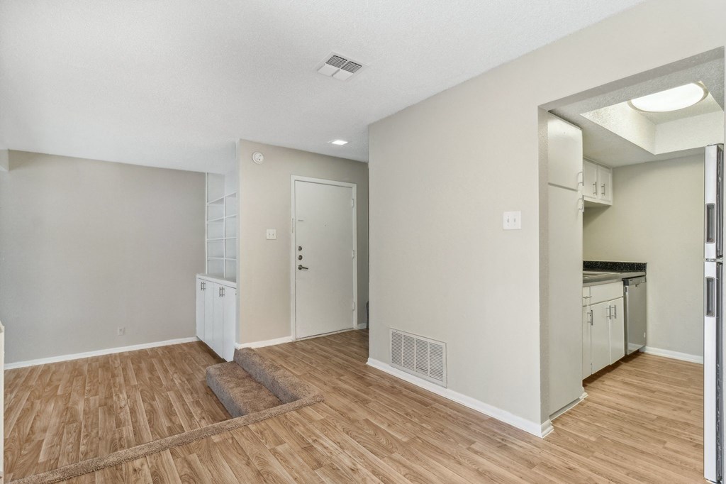 a kitchen and living room with a hard wood floor