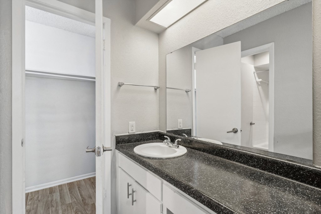 the ensuite bathroom of our A7 apartment at The Escapade with sink and mirror