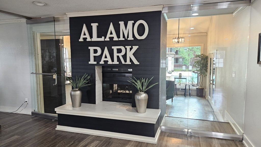 A sign that says Alamo Park is on a black background, San Antonio, 78218