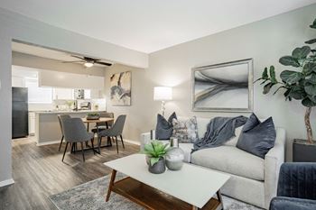 a living room with a couch and a table at Aero White Rock, Texas
