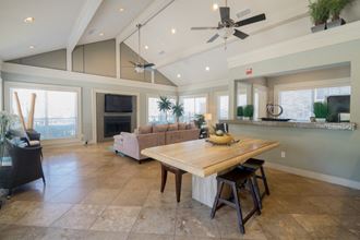 a large living room with a dining room table and a couch