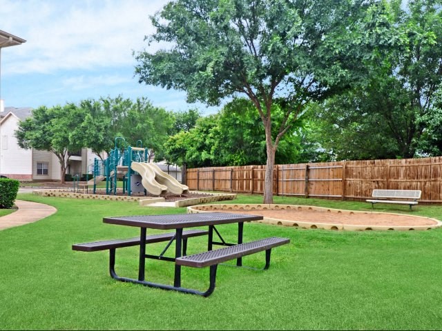 a playground and picnic tables in a yard