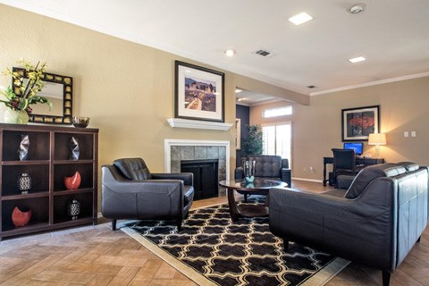 a living room with leather furniture and a fireplace