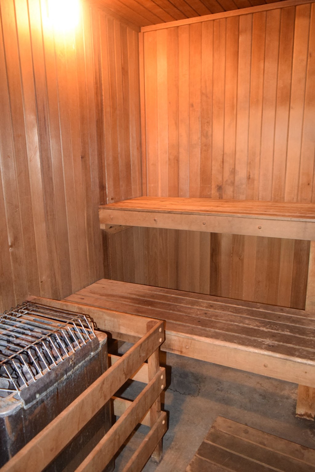 a sauna with wooden walls and a wooden bench