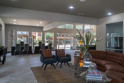 a large living room with a couch and chairs