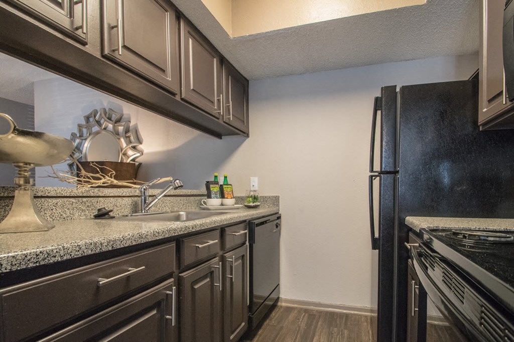 a kitchen with a sink and a refrigerator