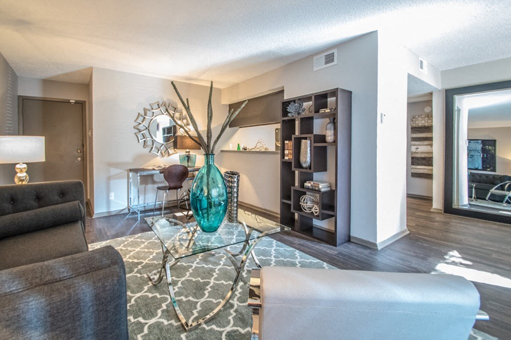 a living room with a couch and a glass table