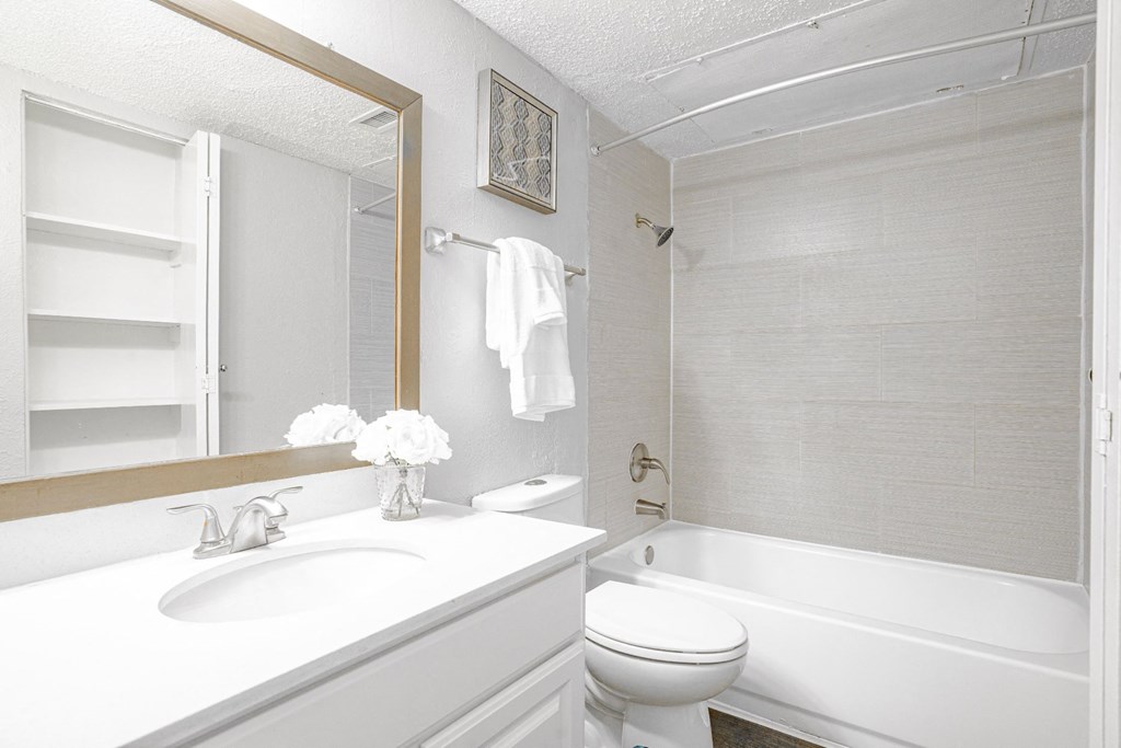 a bathroom with a sink toilet and a tub