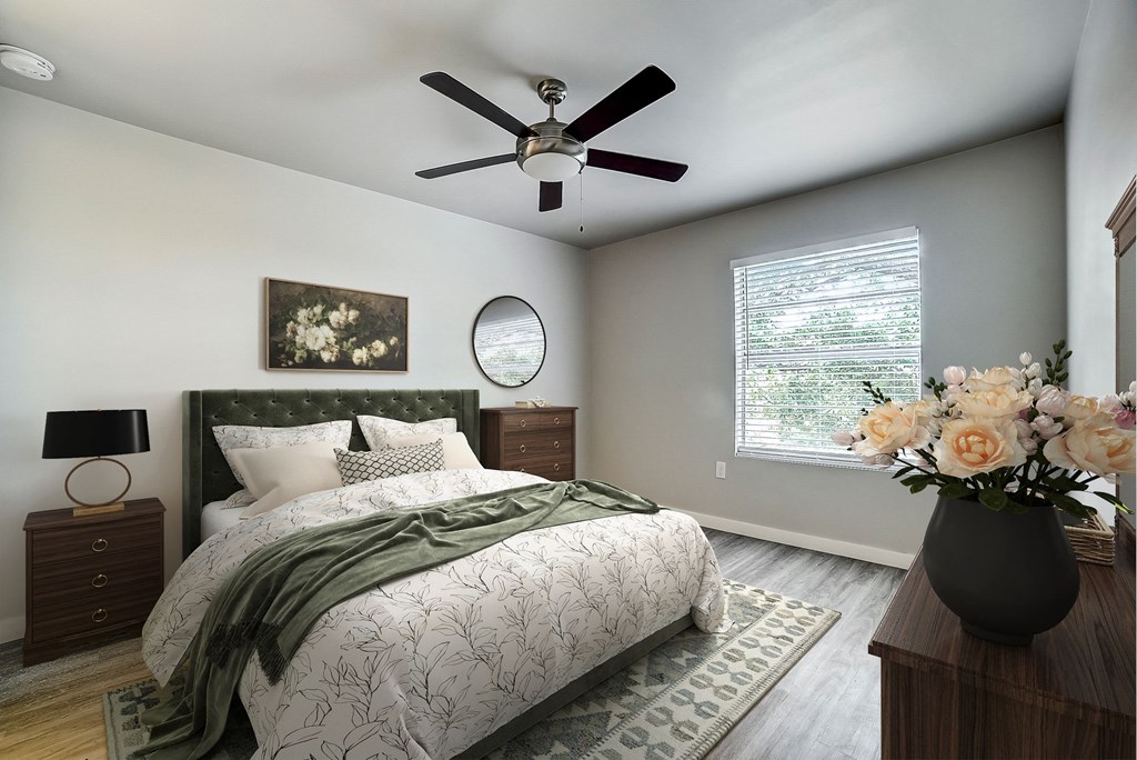 a bedroom with a large bed and a ceiling fan at The Frederick, San Antonio, TX