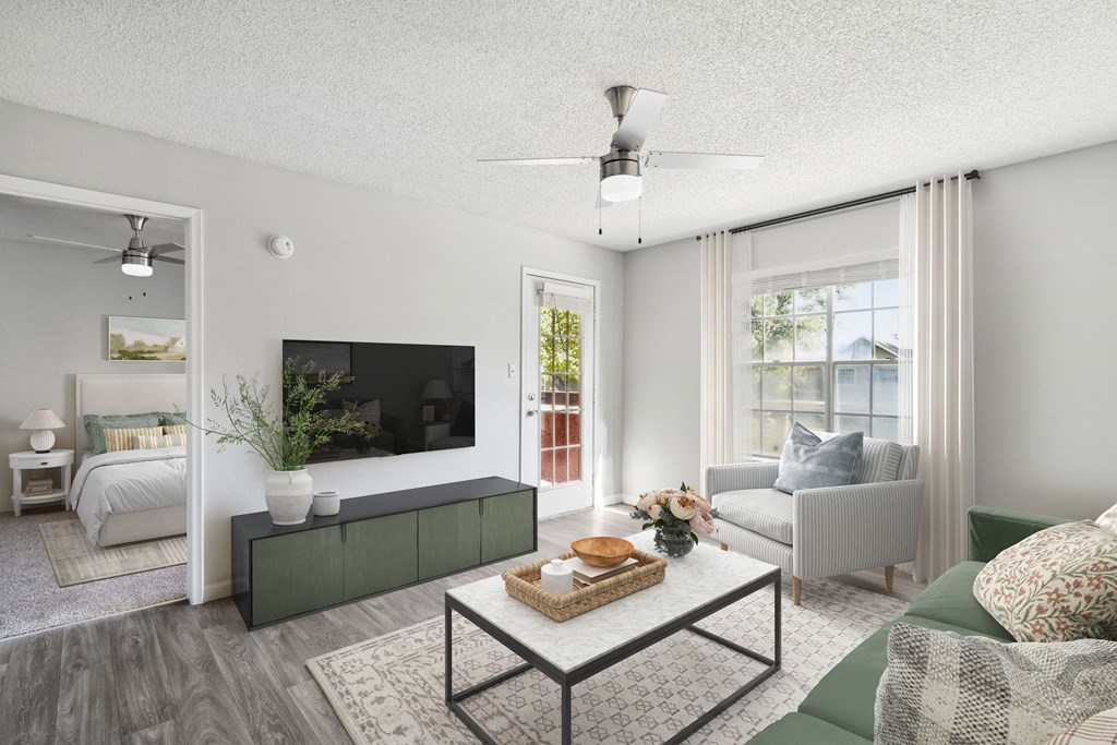 the living room of an apartment with a couch and a tv