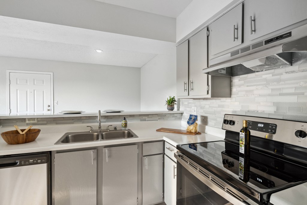 a kitchen with stainless steel appliances and white cabinets