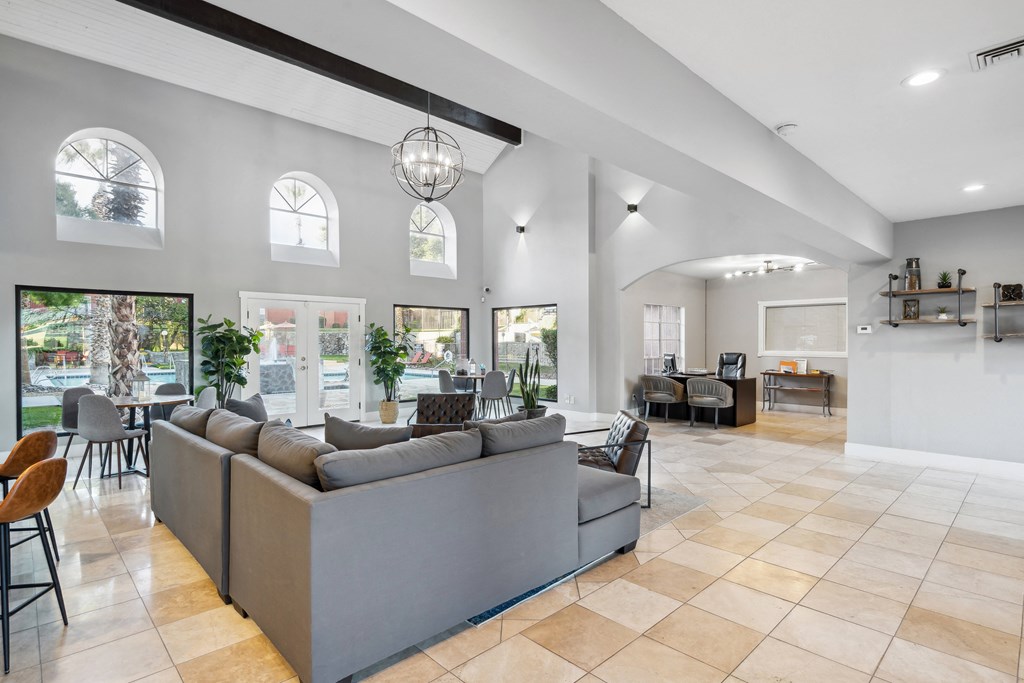a living room with couches and a table with chairs