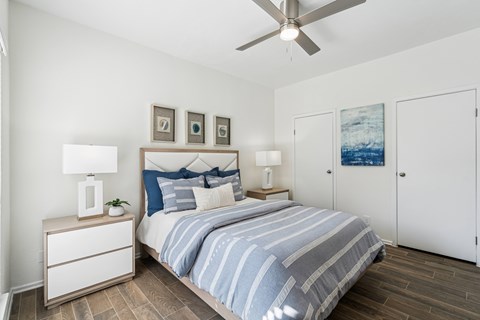 Bedroom with ceiling fan and wood style flooring at Hidden Ridge Apartments, Texas, 75038