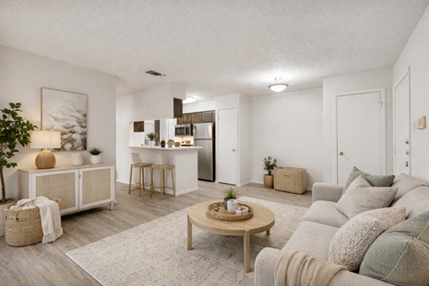 A living room with a grey couch and a wooden coffee table.