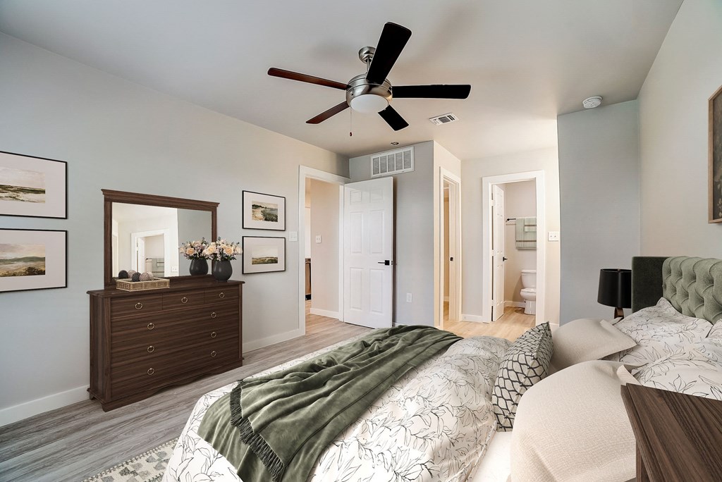 a bedroom with a large bed and a ceiling fan at The Frederick, Texas, 78240