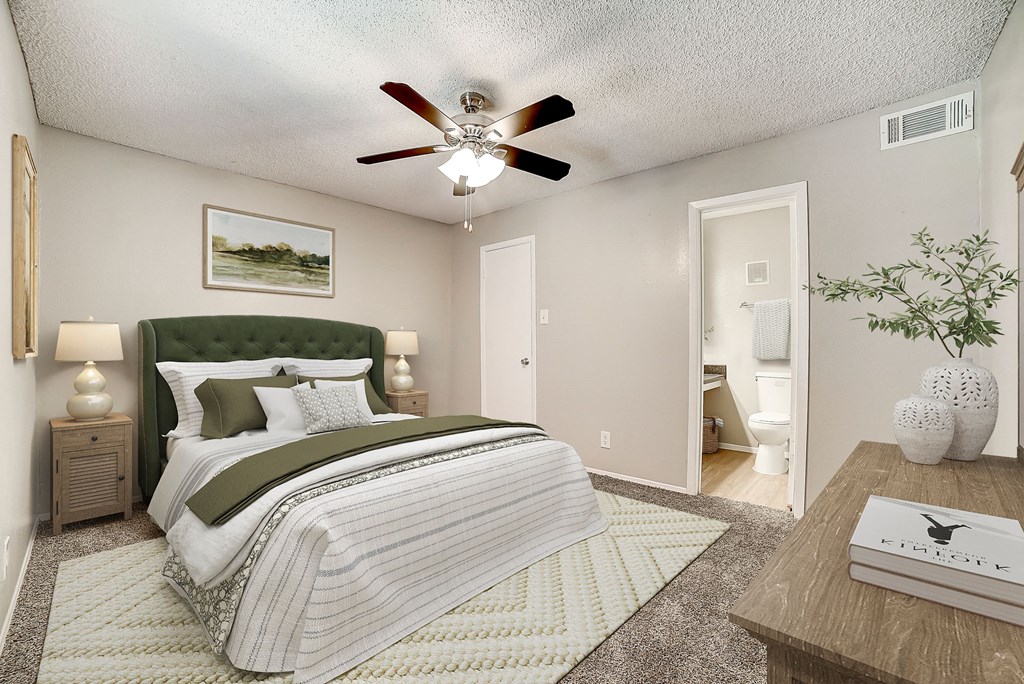 a bedroom with a bed and a ceiling fan