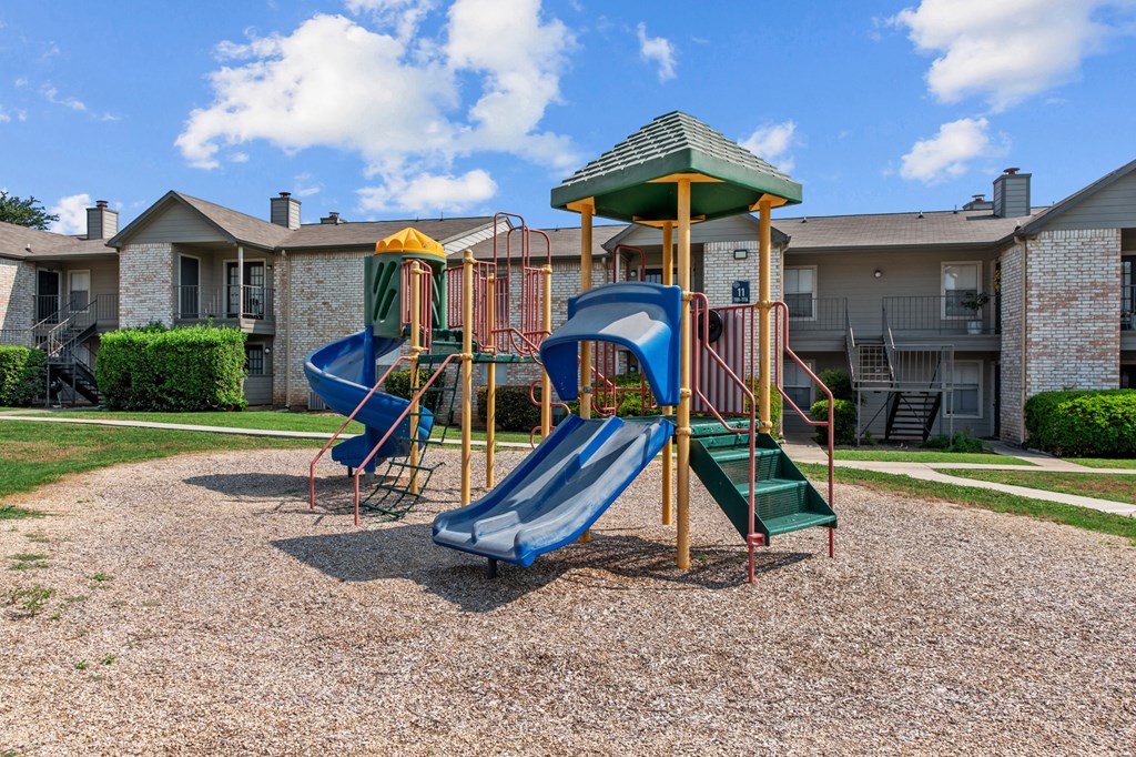 a playground at the whispering winds apartments in pearland, tx