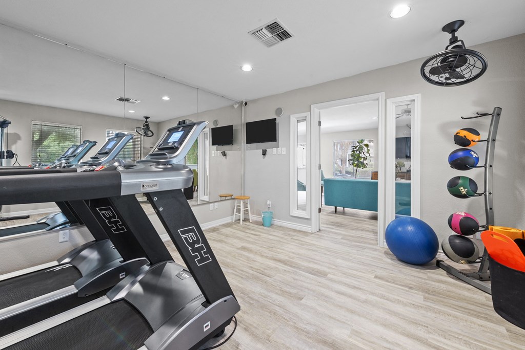 a gym with treadmills and other exercise equipment
