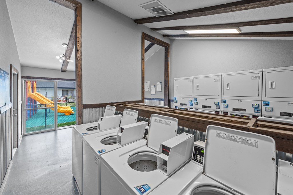 a washer and dryer facility with a playground in the background