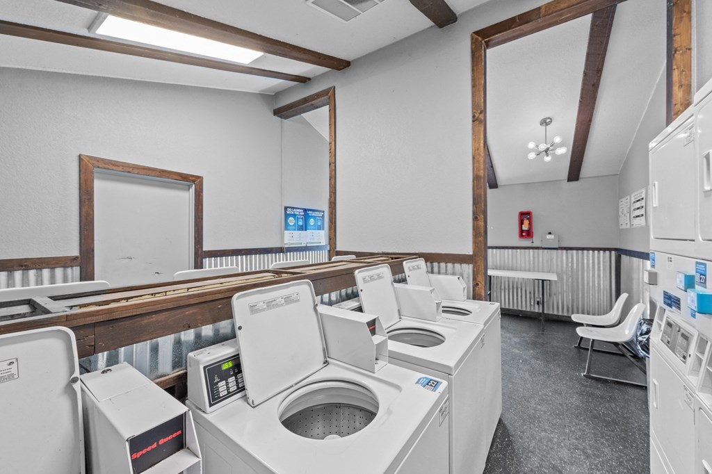 a laundry room with washers and dryers
