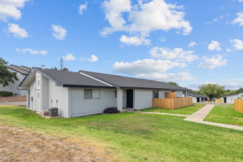 a row of houses with a blue sky in the background