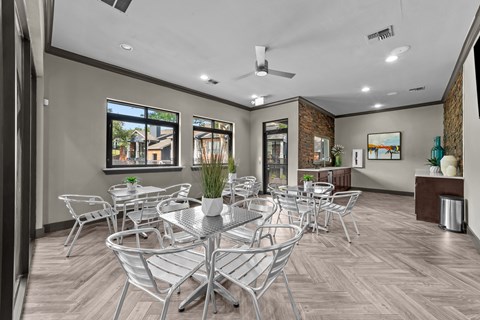 A modern dining room with a glass table and chairs.