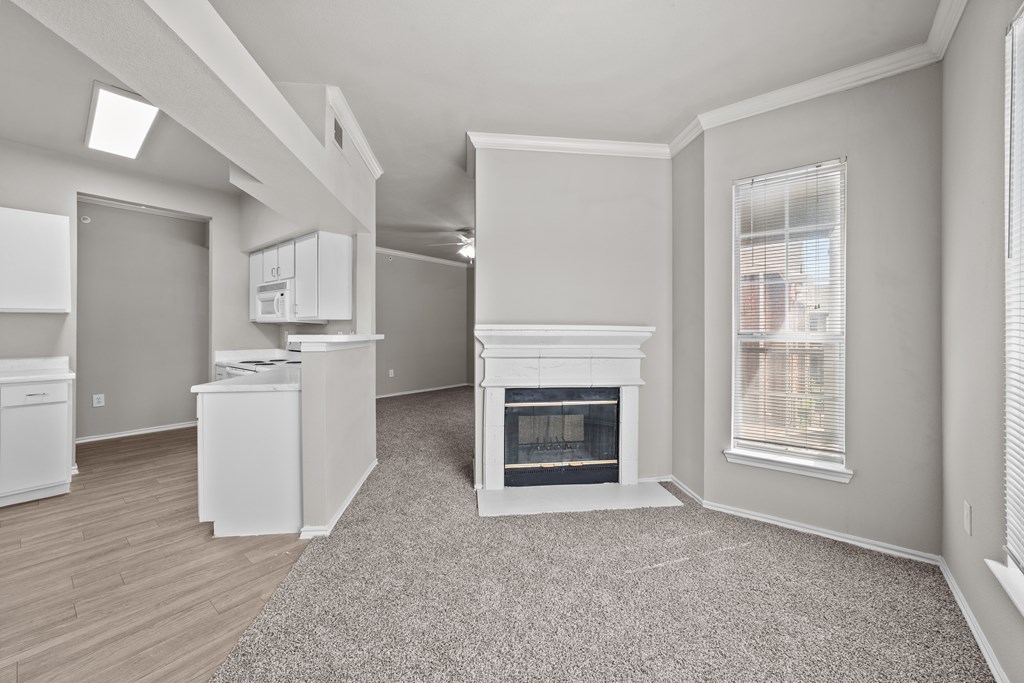 A spacious living room with a fireplace and a dining area.