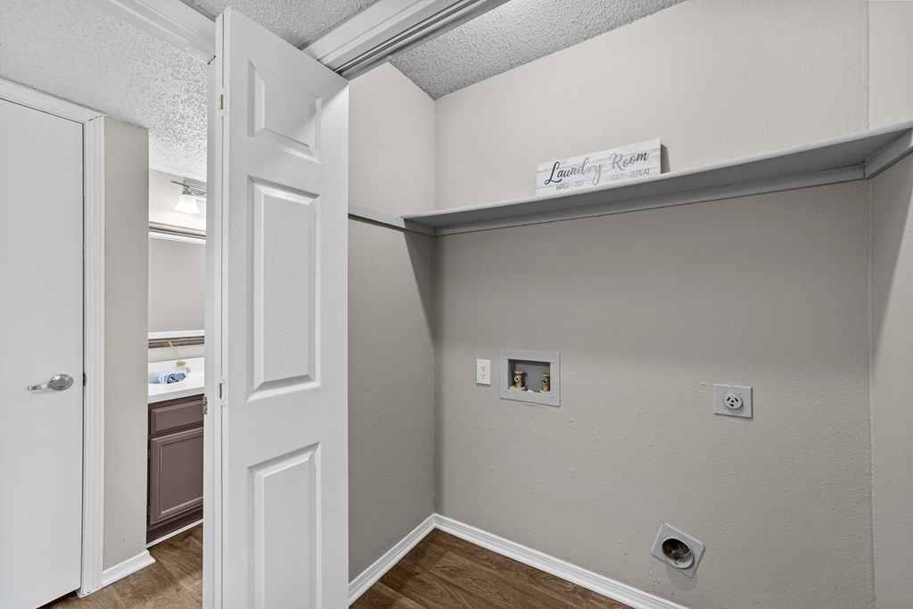 Laundry room with a door and a sign above it.
