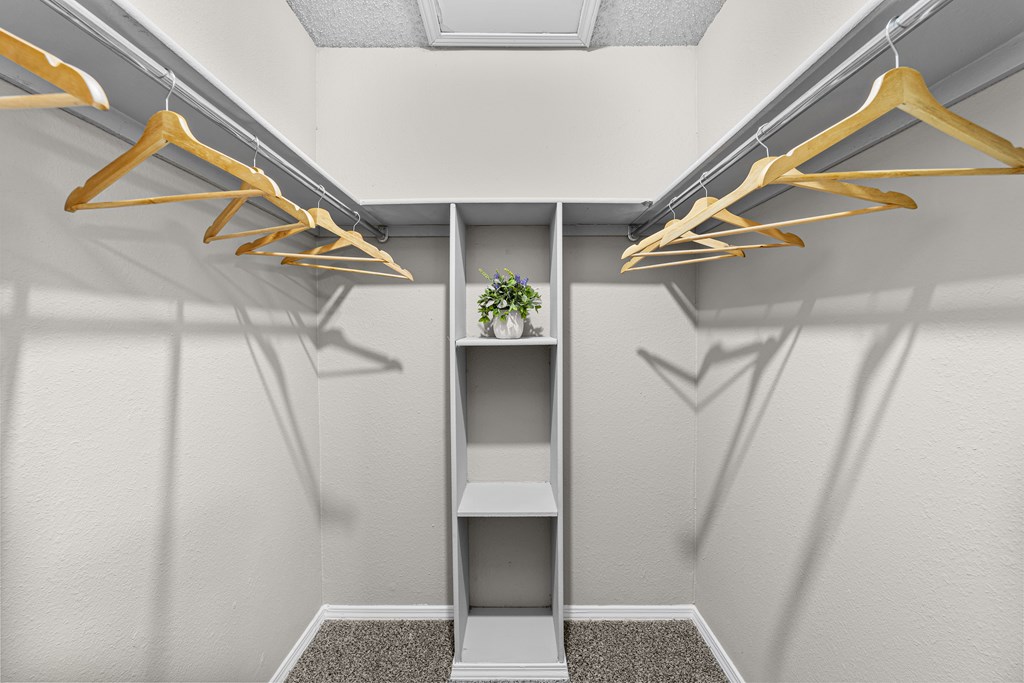 Closet with a shelf and hangers.