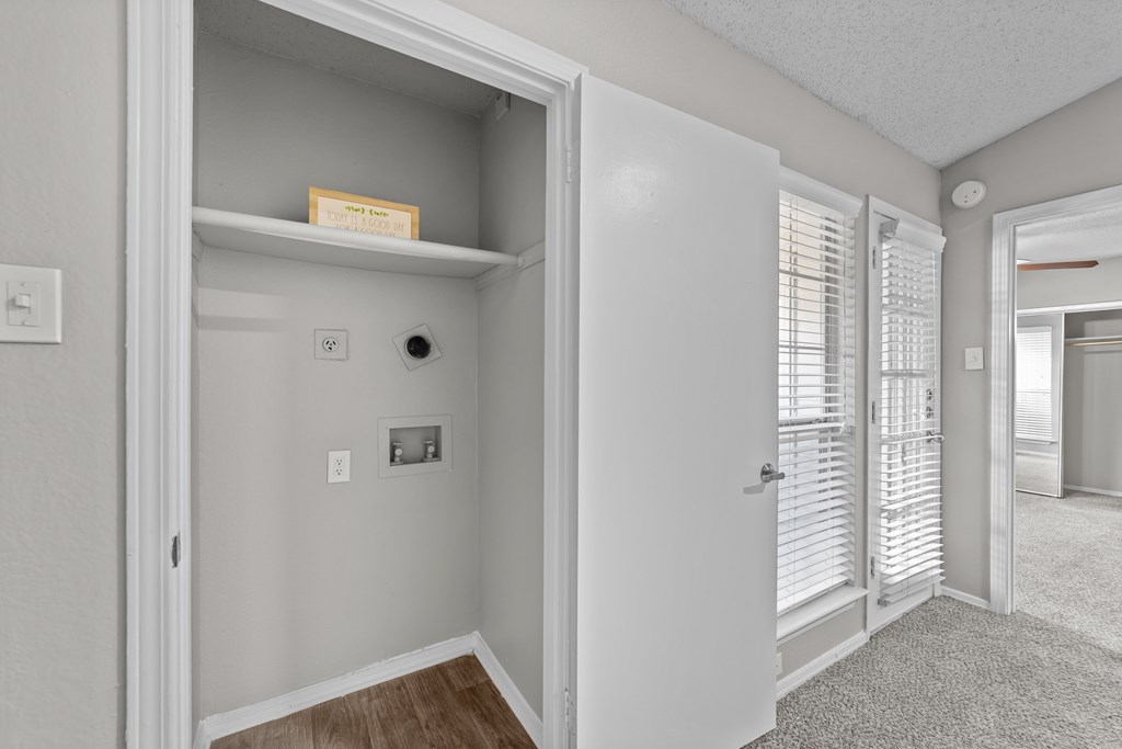 A white door is open to a hallway.