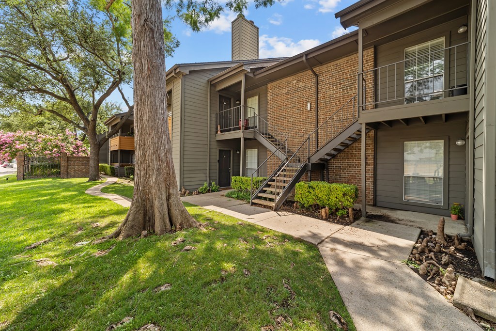 A tree is in front of a house.