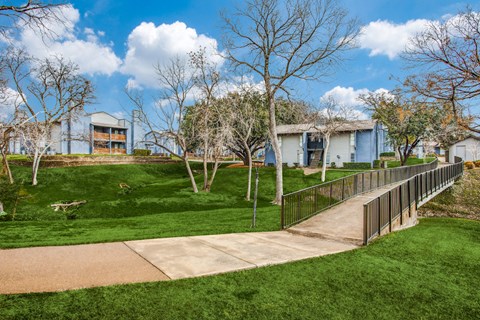 a sidewalk leading to a house in a park