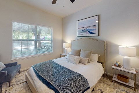 a bedroom with a large bed and a large window  at Remington Ranch, Texas, 78247