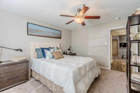Bedroom with ceiling fan and walk-in closet at Amherst Apartments, Texas, 76021