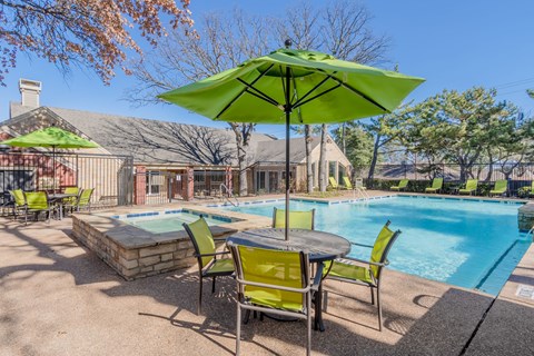 Resort style swimming pool with spa and patio seating at Amherst Apartments, Bedford, TX 76021