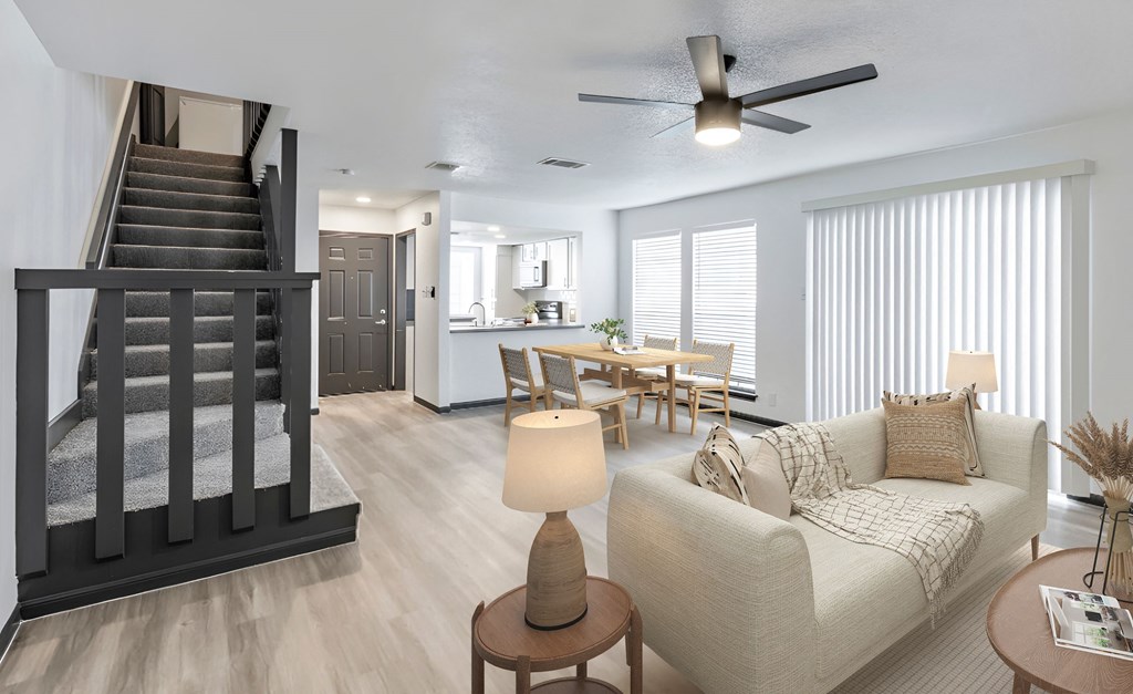 a living room with a staircase in the background and a couch in the foreground at Tradewinds, Windcrest, TX