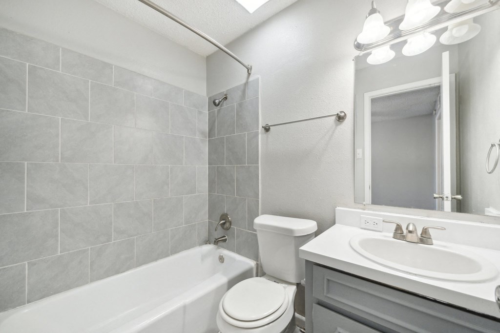 a bathroom with a sink toilet and a bath tub