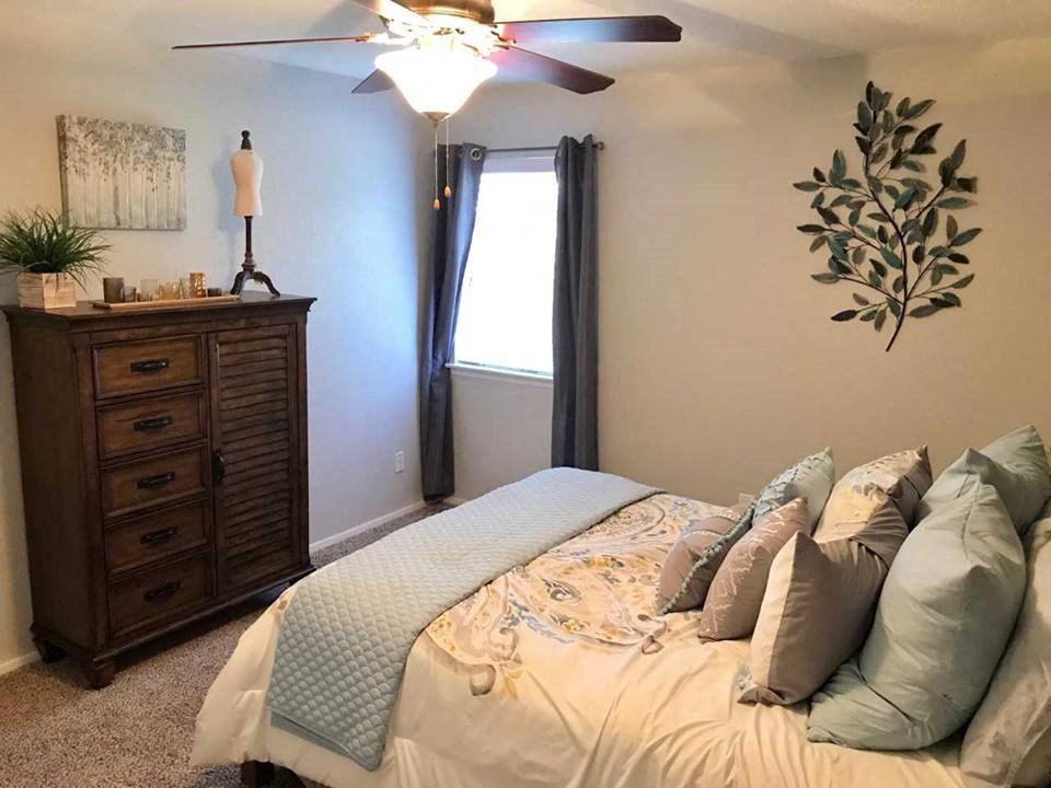 a bedroom with a bed and a dresser