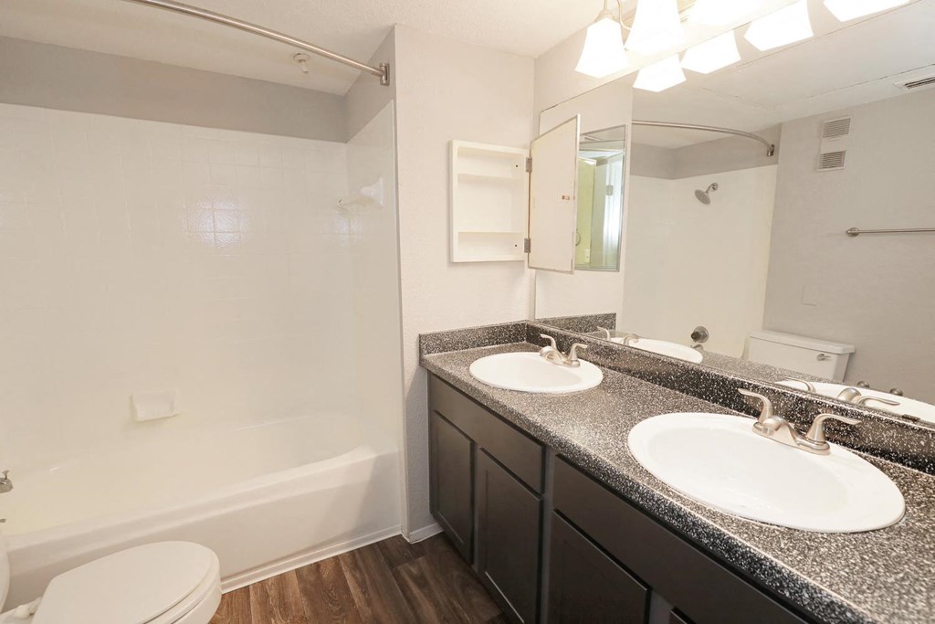 a bathroom with two sinks and a bathtub