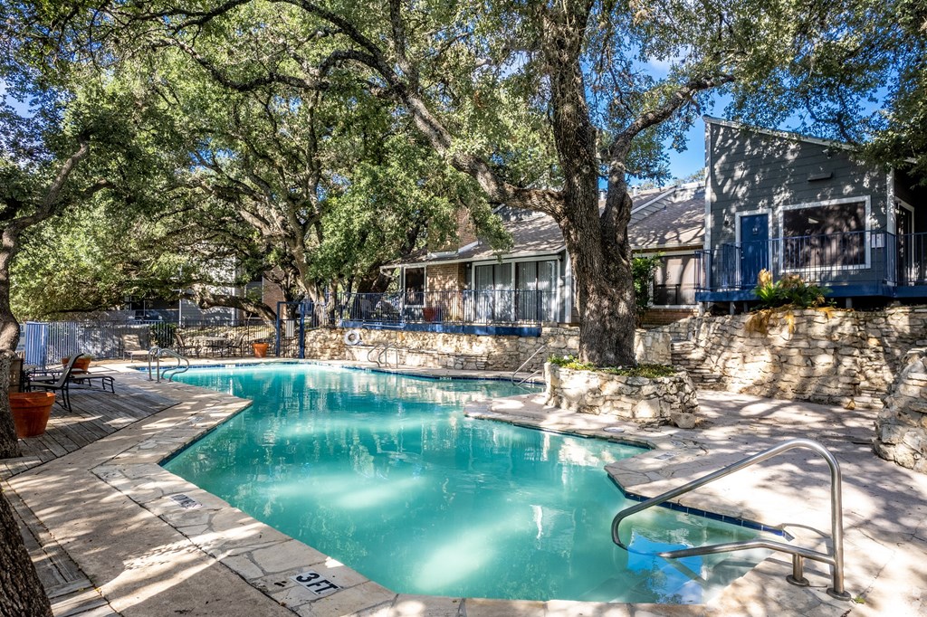 a swimming pool with a house in the background at The Frederick, San Antonio, 78240